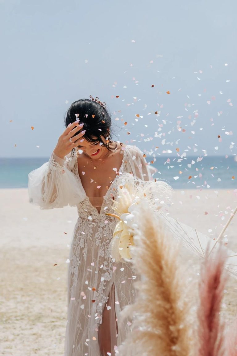 Bride laughing as confetti falls at a beach wedding in Cabo de Gata