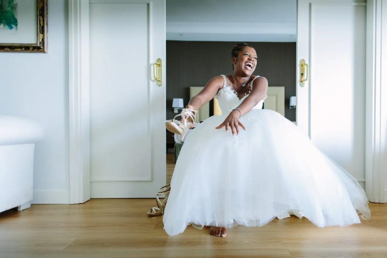 Bride twirling joyfully in her wedding dress while getting ready