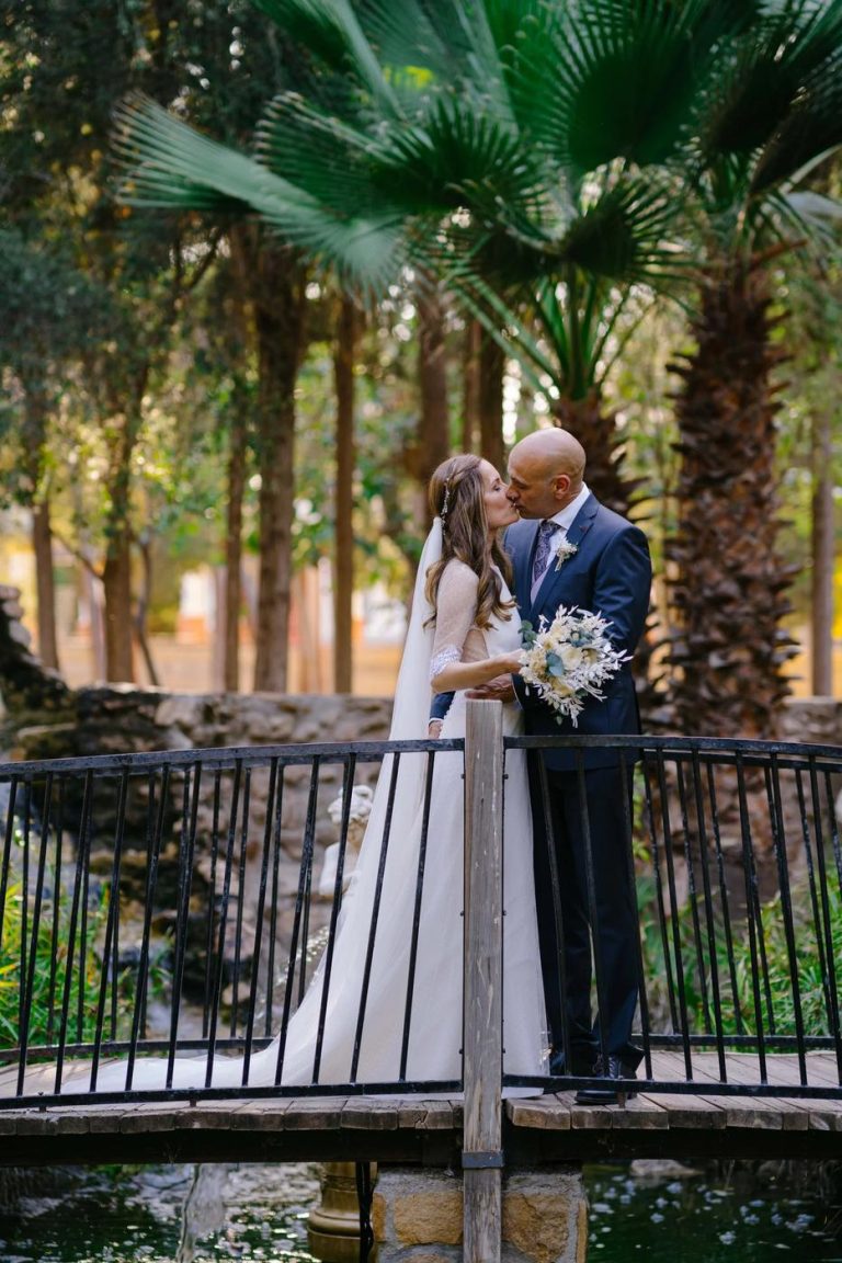 Couple on a small bridge among palm trees