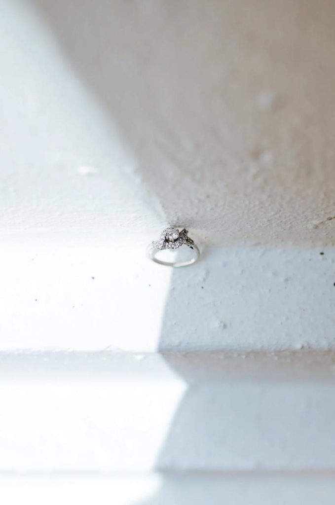 Engagement ring resting on white steps