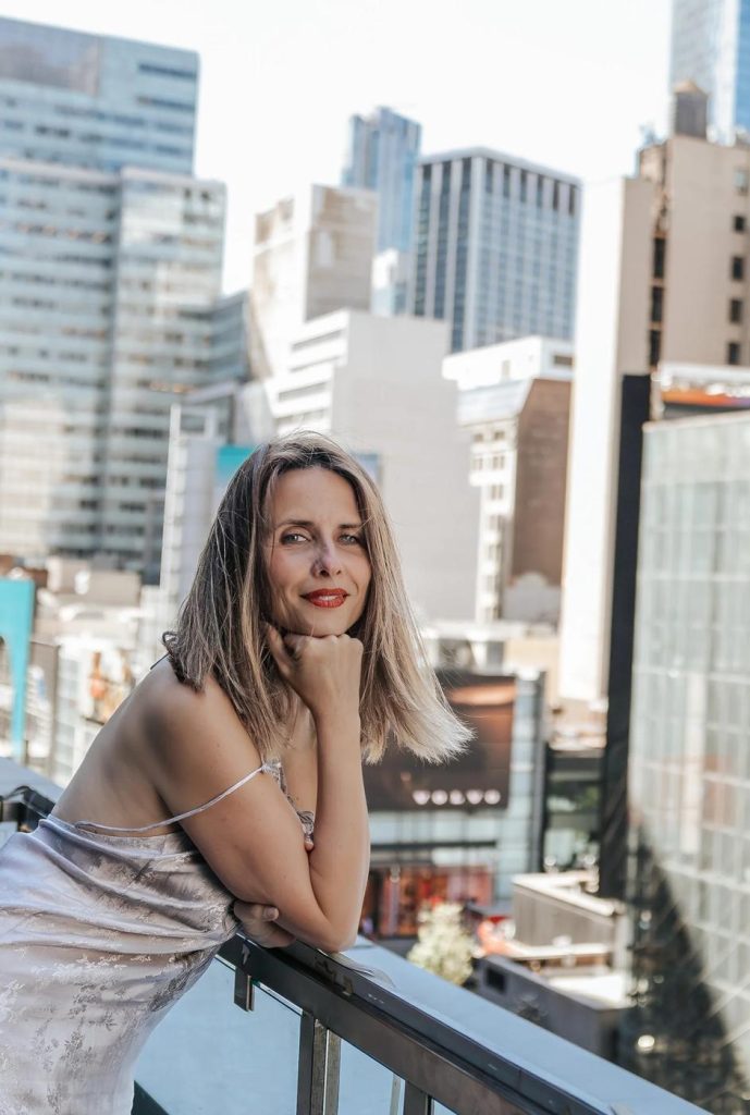 Portrait of photographer Marie on a city balcony